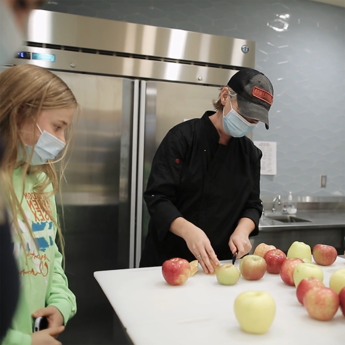 Photo of students in masks working in the Eden Hall Campus Kitchen Lab